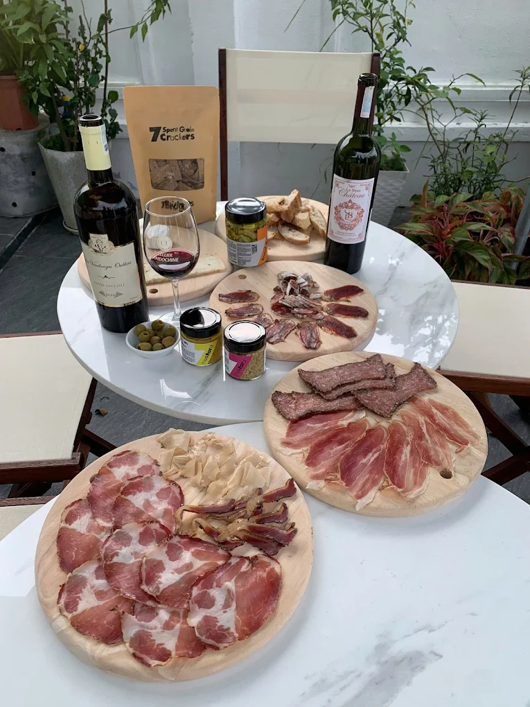 Wine, cheese and charcuterie laid out on a table
